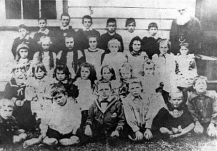 1898 Raglan School photo with headmaster James La Trobe on the right. Elsie Fitz William nee Rendell is second from the left in the third row from the back.