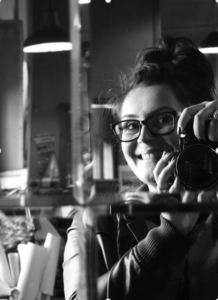 Clarissa Machado posing ready to take a photograph with her camera